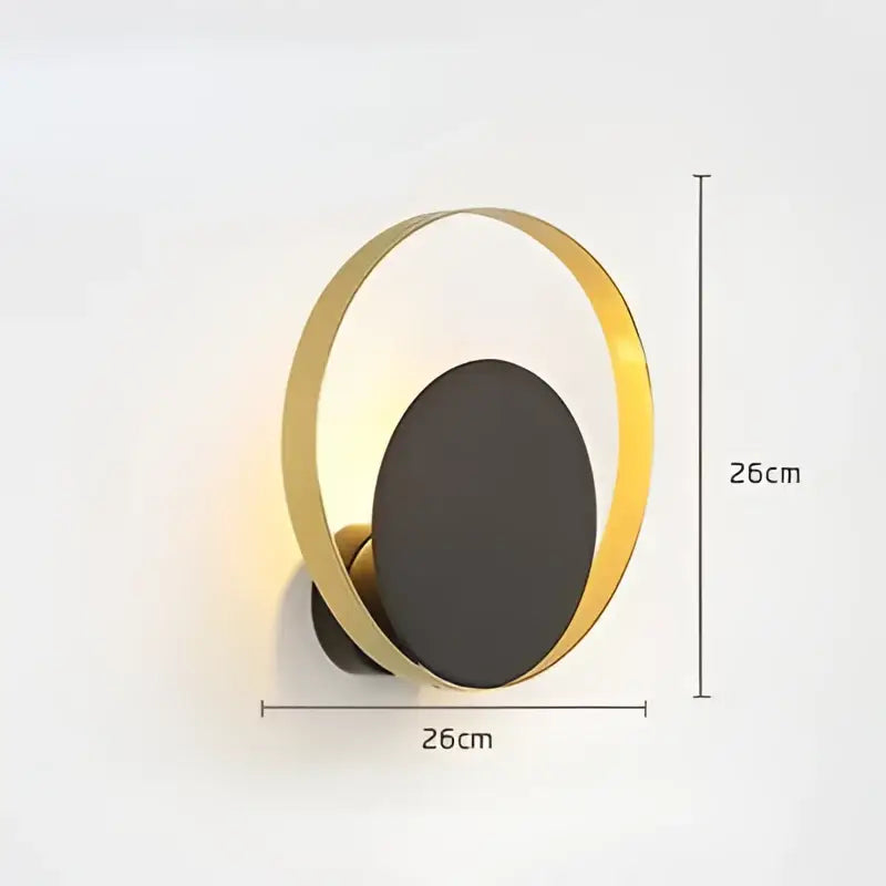 Modern gold and black wall sconce with 26cm diameter featuring a black oval center for decorbites elegant led wall lighting