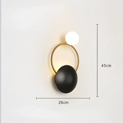 Gold-toned circular wall sconce with matte black spherical base and white globe light for elegant led wall decorbites elegant led