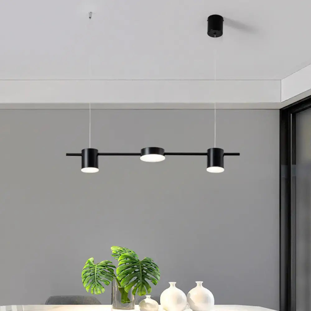 Decorbites modern black cylindrical pendant light with three warm white light fixtures on sleek horizontal bar