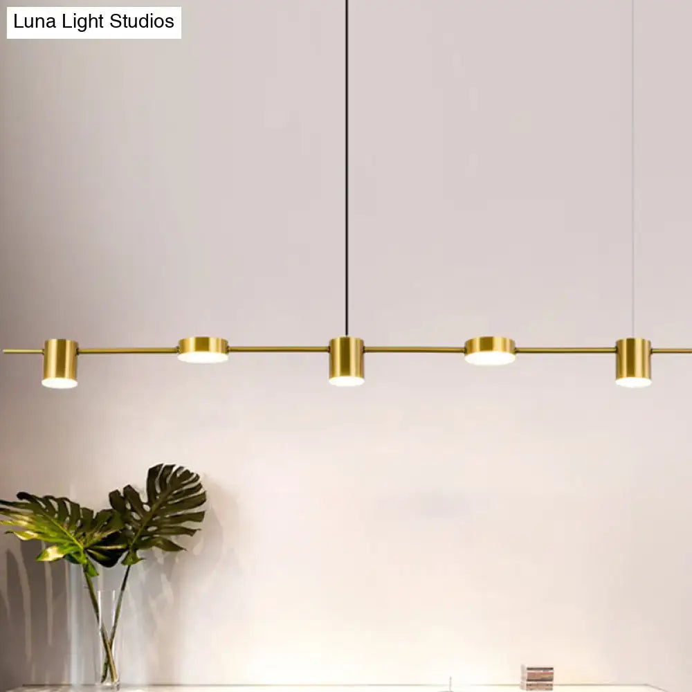 Decorbites™ modern linear metallic chandelier with five gold-toned cylindrical fixtures in black gold finish emitting warm white light