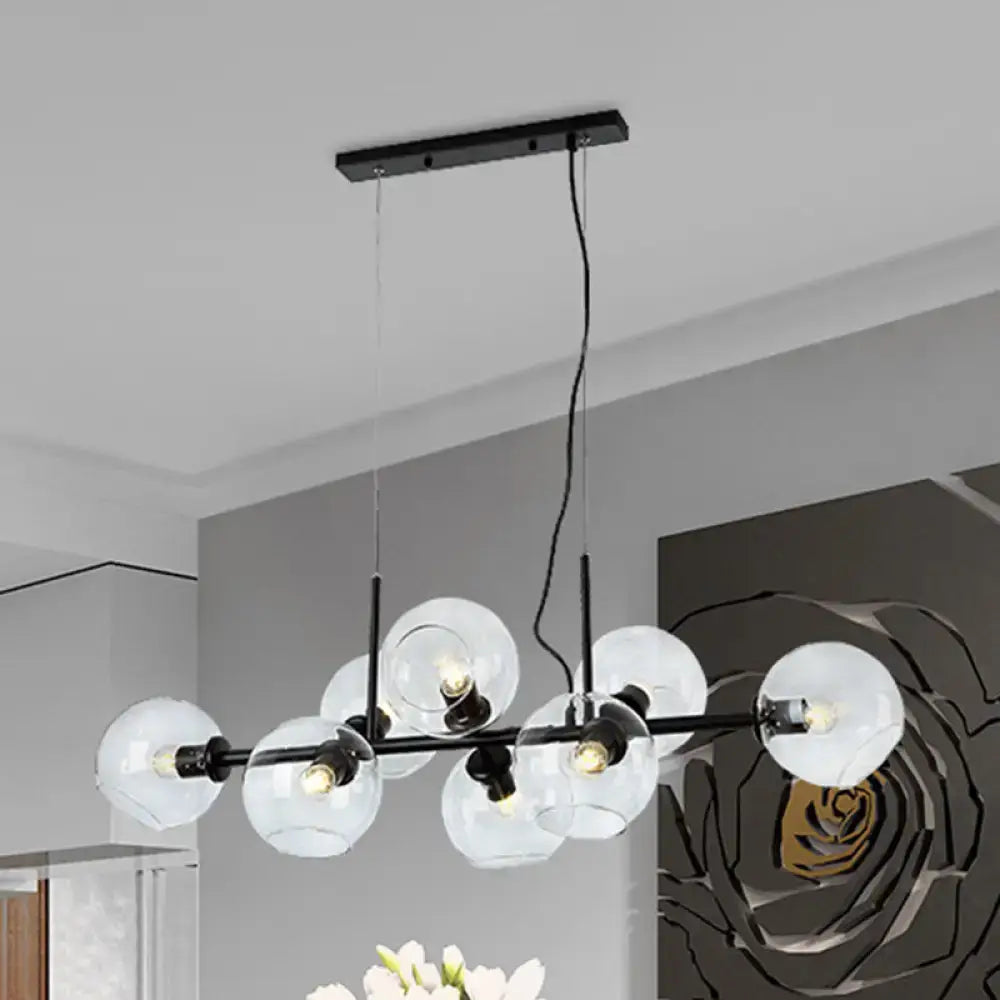 Modern black metal chandelier with smoky glass globe shades and linear design ideal for kitchen island lighting fixture width
