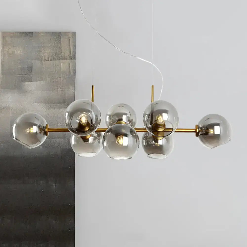 Modern brass bar pendant light with six smoky glass globe bulbs in gold and black linear design fixture width for kitchen island