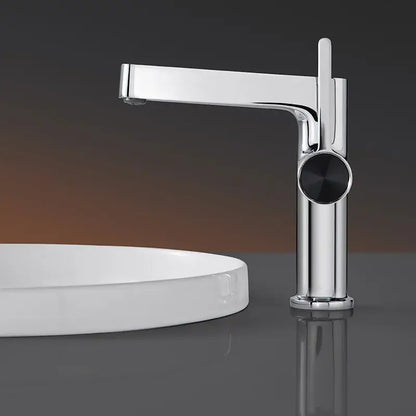 Modern gold and black decorbites basin faucet with sleek chrome body and minimalist black circular handle for bathroom use