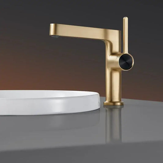 Modern gold and black minimalist basin faucet with sleek design and black circular handle by decorbites basin faucet