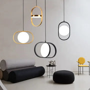 Modern gold and black oval pendant lights with sleek frames and bright white circular bulbs for kitchen decorbites pendant lights