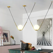 Modern gold and black pendant light with spherical frosted glass shades by decorbites golden black perle for dining room decor