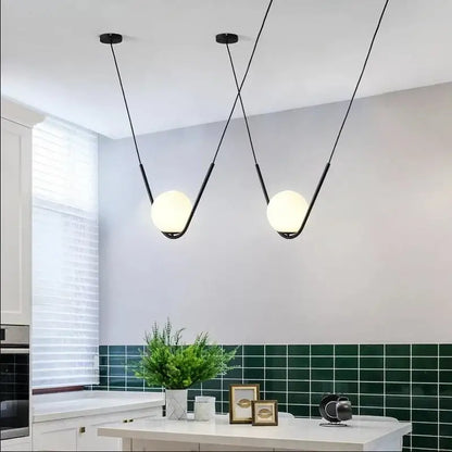 Modern gold and black pendant light with black metal and spherical frosted glass shades for dining room decorbites golden black perle
