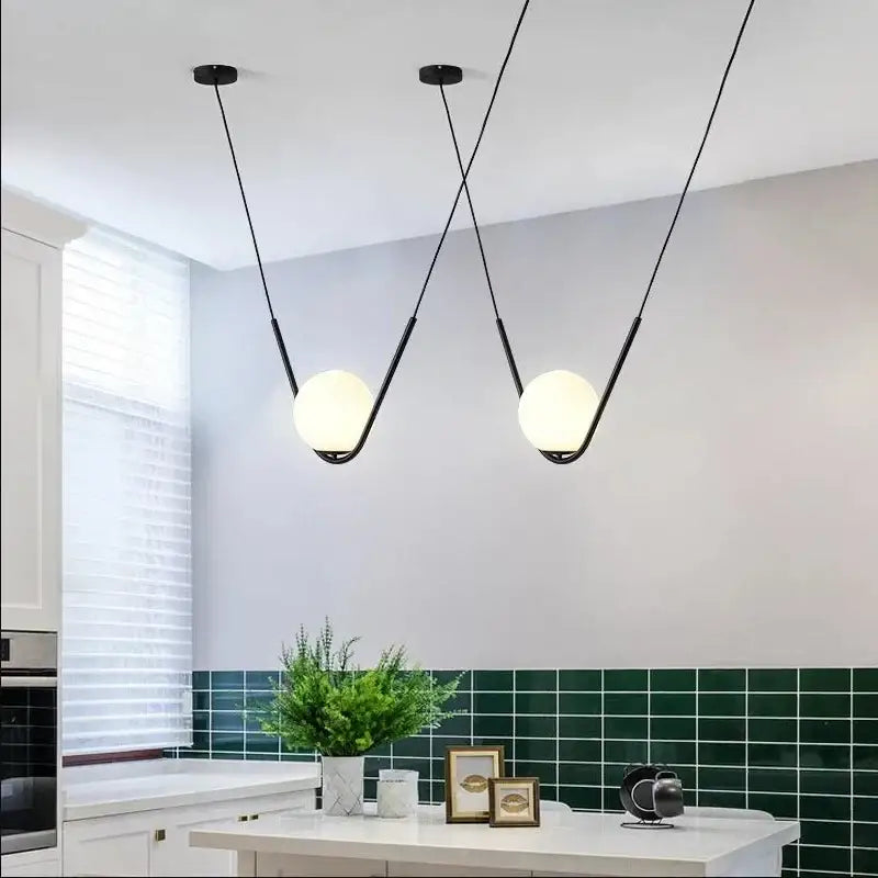 Modern gold and black pendant light with black metal and spherical frosted glass shades for dining room decorbites golden black perle