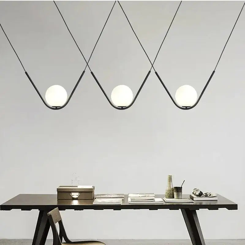 Modern black metal pendant light with three spherical white glass globes for dining room decorbites golden black style