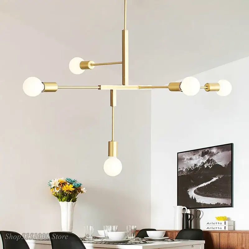 Modern gold and black pendant light with six frosted glass bulbs in a decorbites cross style design for dining room decor