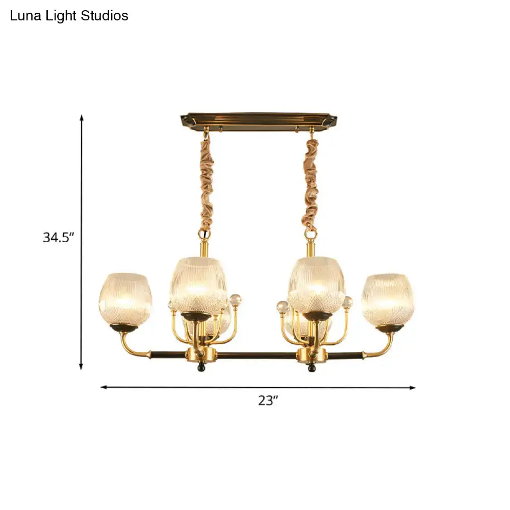 Modern gold and black ribbed glass island chandelier with four textured glass shades and twisted rope-like chains