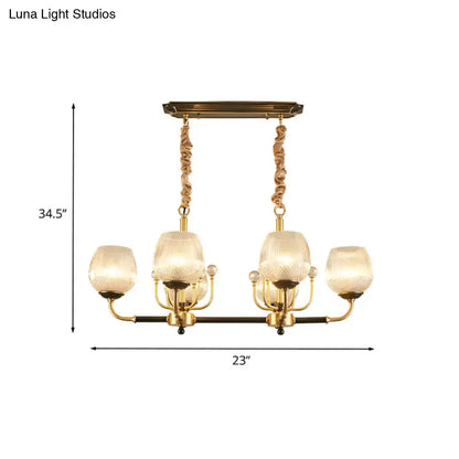 Modern gold and black ribbed glass island chandelier with four textured glass shades and twisted rope-like chains