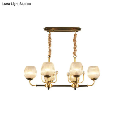 Modern gold and black ribbed glass island chandelier with gold-toned frame and four frosted ribbed glass shades suspended by twisted cords