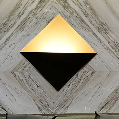 Modern gold and black square wall sconce with a two-tone design and fixture height for bedroom led lighting