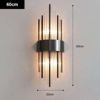 Modern gold and black stainless steel wall sconce with sleek metallic base and vertical glass rods for warm living room decorbites gold stainless lighting