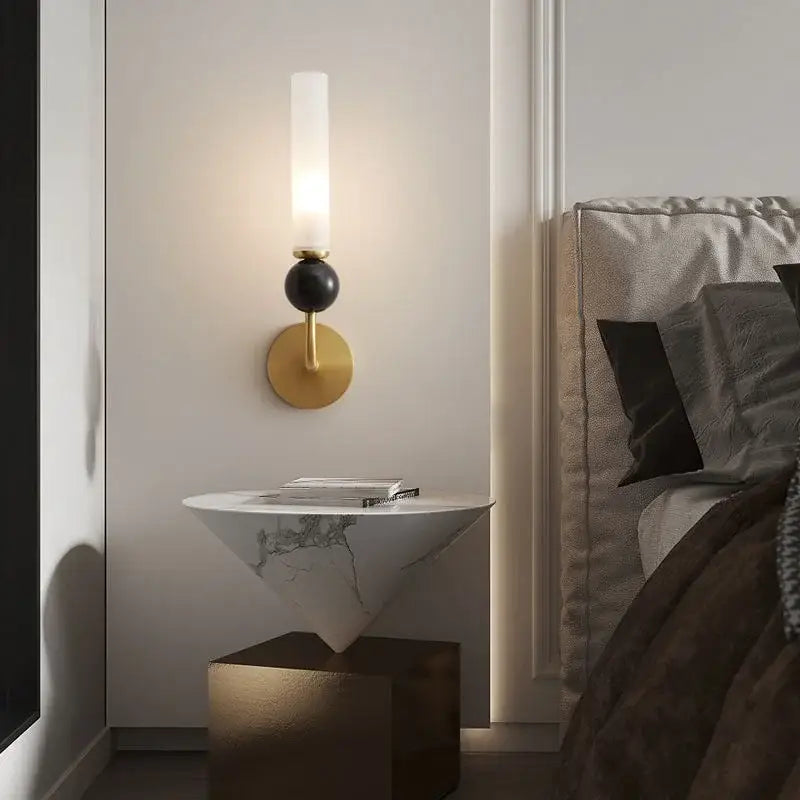 Modern wall lamp with black spherical accent copper base and frosted glass shade for living room decor