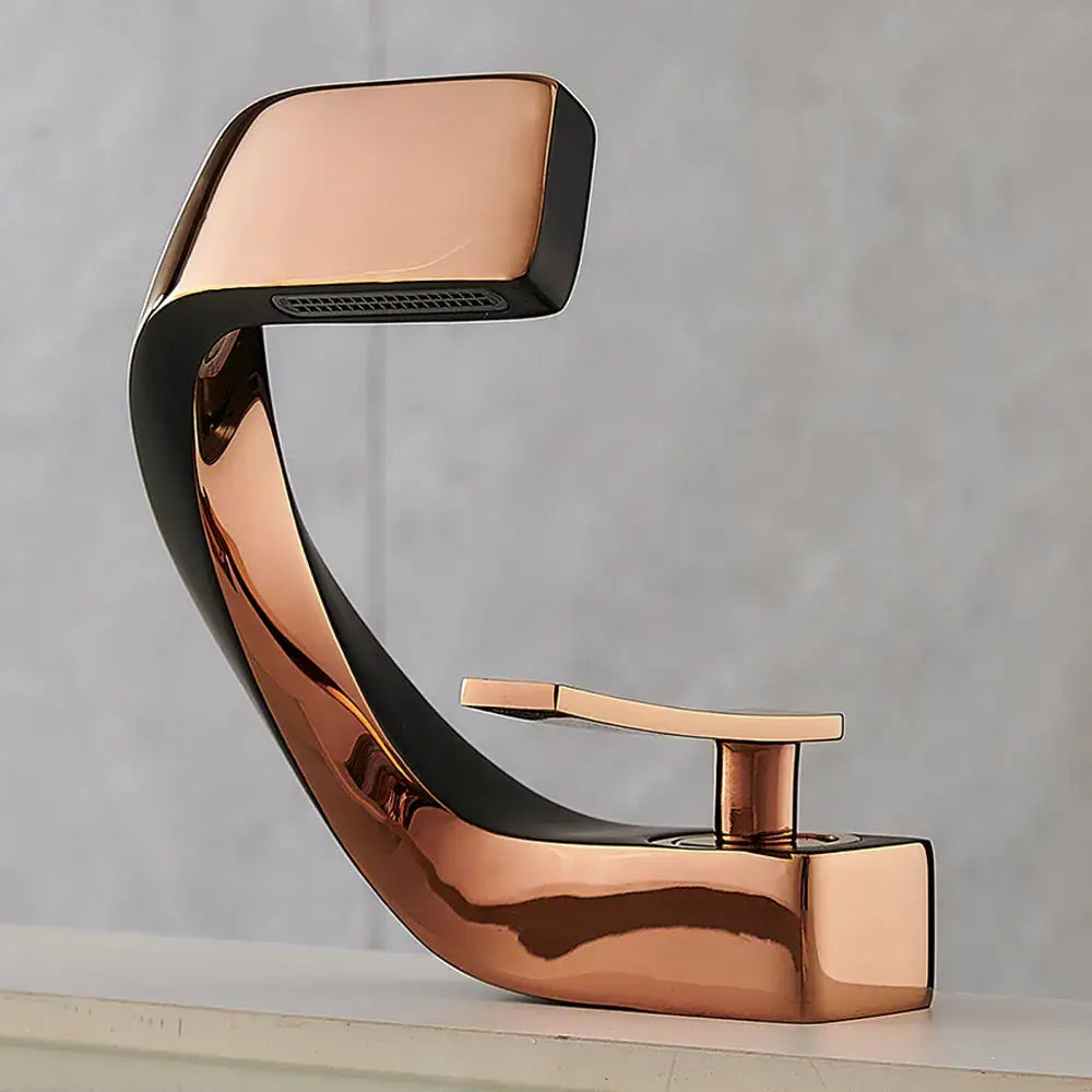 Modern gold and black waterfall basin faucet with copper finish sleek curved design and black accent trim for bathroom use