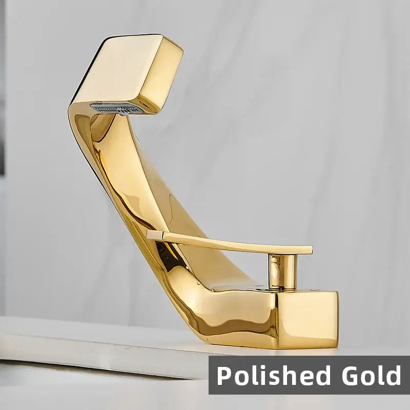 Polished gold modern basin faucet with sleek angular design and single lever handle for bathroom fixtures