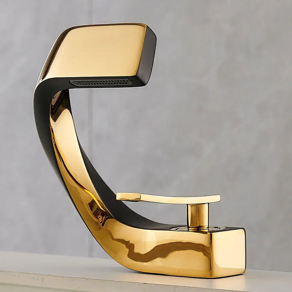 Modern gold and black basin faucet with sleek curved design for a stylish waterfall bathroom fixture