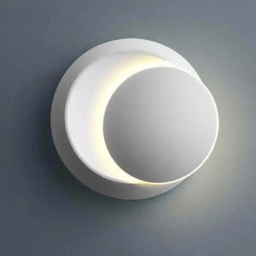 White ceramic wall sconce with sleek crescent design and soft lighting in modern gold black decorbites adjustable led