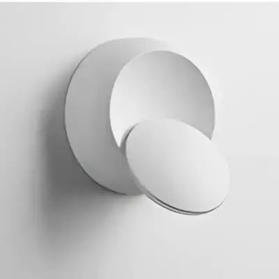 White minimalist wall-mounted sculpture with smooth circular forms complementing decorbites adjustable led crescent wall light