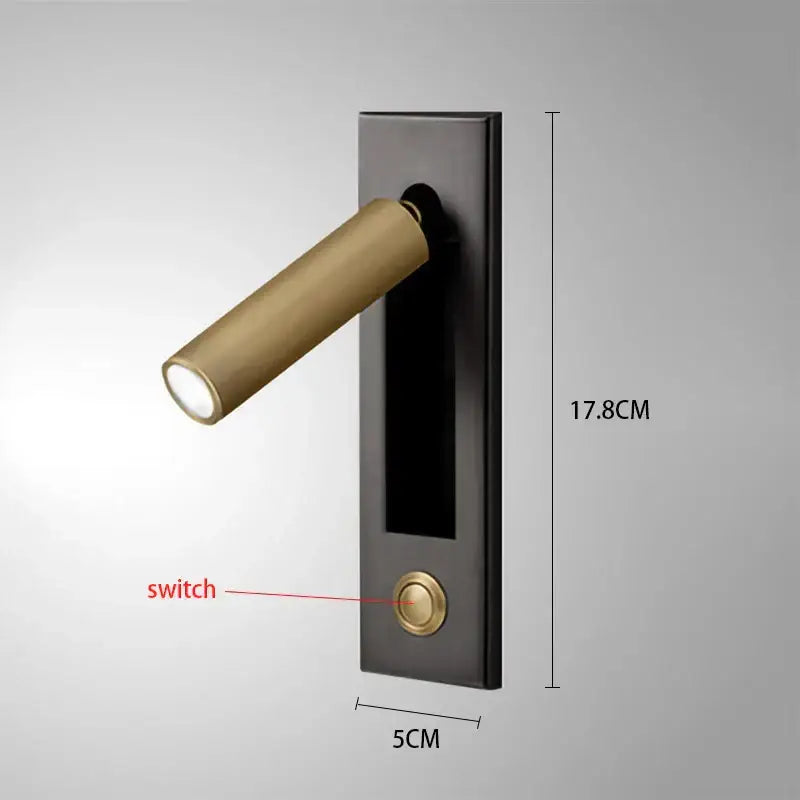 A modern gold black and white led wall lamp with a matte black base and brass head for bedroom reading use