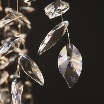 Clear faceted crystal pendants with iridescent reflections on modern gold decorbites branch crystal chandelier