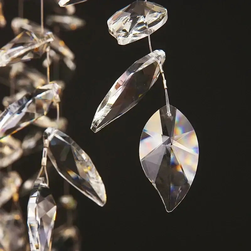 Clear faceted crystal pendants with iridescent reflections on modern gold decorbites branch crystal chandelier