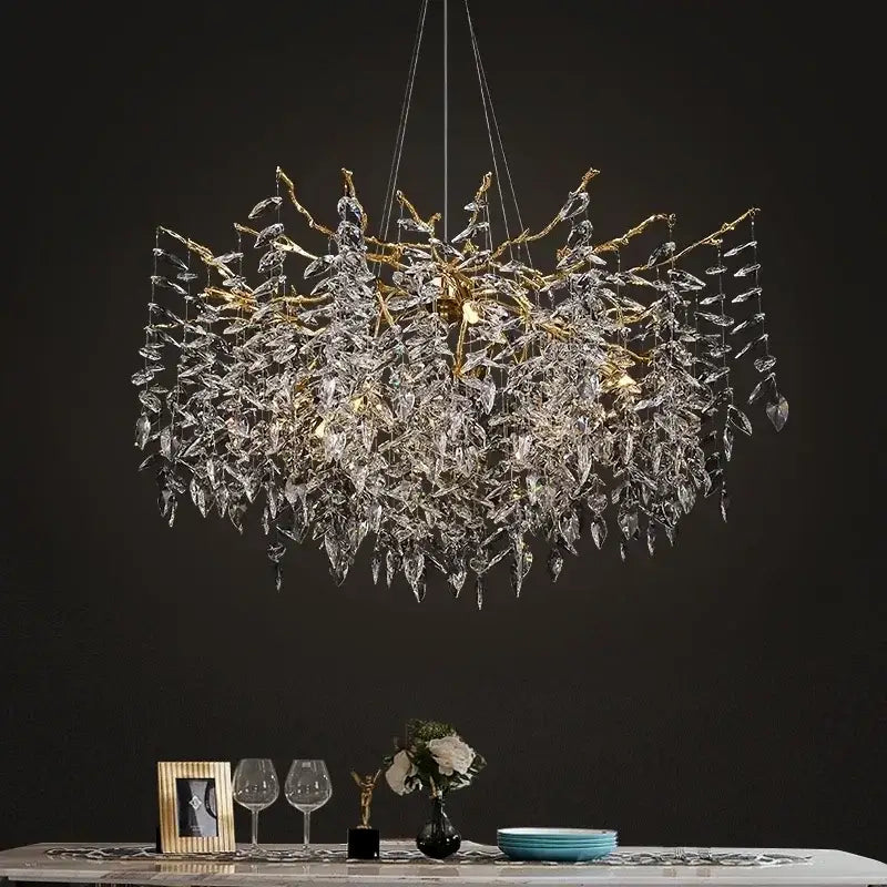 A luxurious modern gold branch crystal chandelier with intricate leaf design hanging from a dark ceiling for dining room decorbites branch crystal lighting