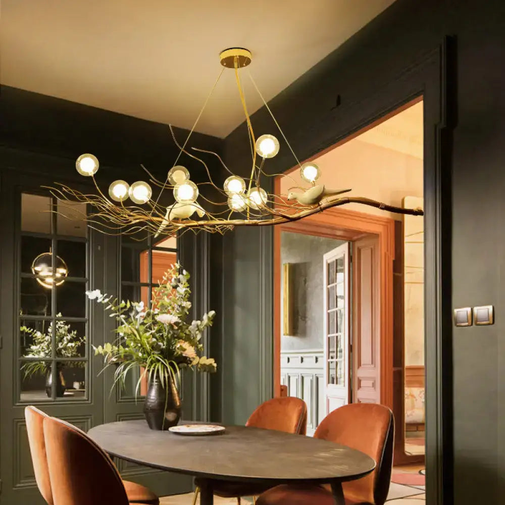 Modern gold branch pendant light with clear glass spherical bulbs and bird figurine ideal for dining room light type