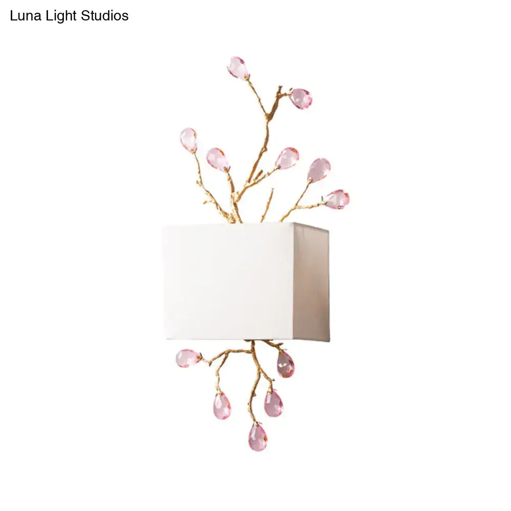 Modern gold branch wall sconce with white fabric shade and pink crystal accent for elegant bedroom lighting