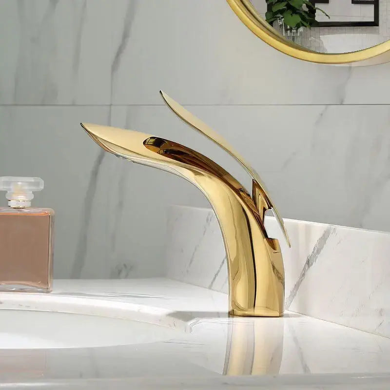 Modern gold brass basin faucet with sleek flowing design for bathroom sink mixer by decorbites brass basin