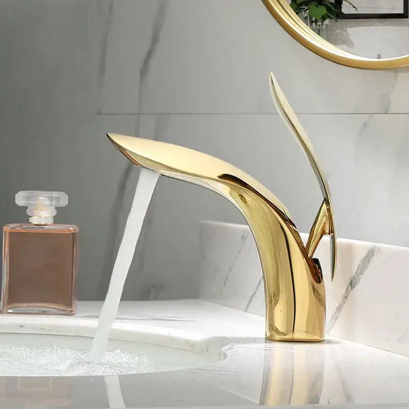 Modern gold brass basin faucet with sleek flowing design for bathroom sink mixer by decorbites brass basin