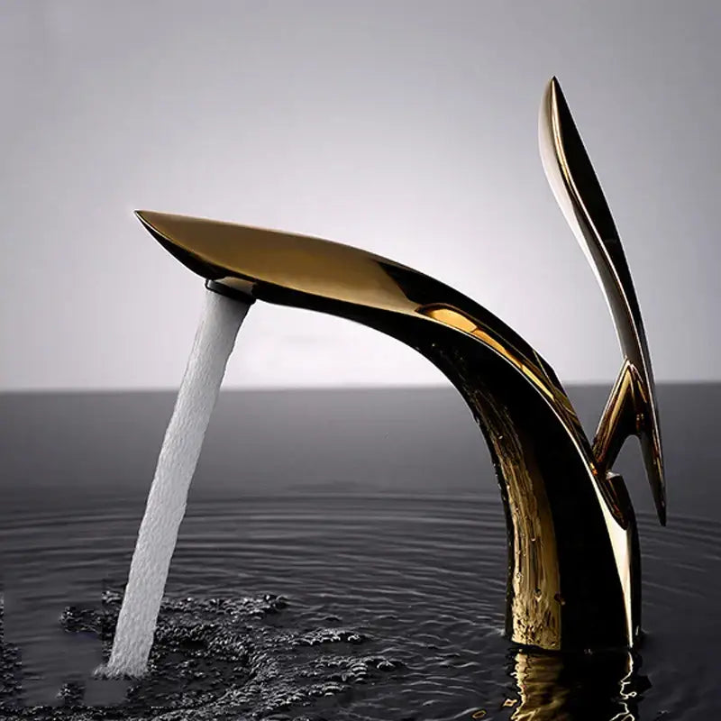 A sleek modern decorbites brass basin faucet in gold with a flowing sculptural design for bathroom sink mixer