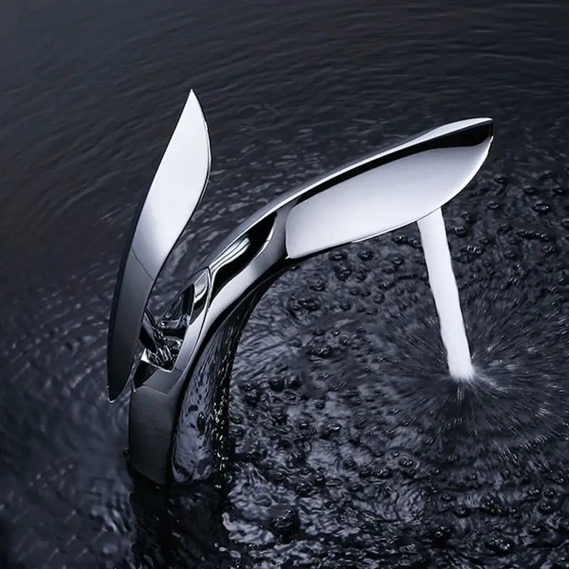 Modern gold brass basin faucet by decorbites with sleek chrome wing-like design and flowing water stream