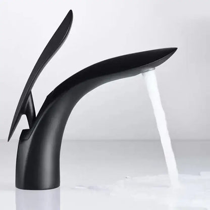 Modern black matte brass basin faucet by decorbites with sleek sculptural design and flowing water stream
