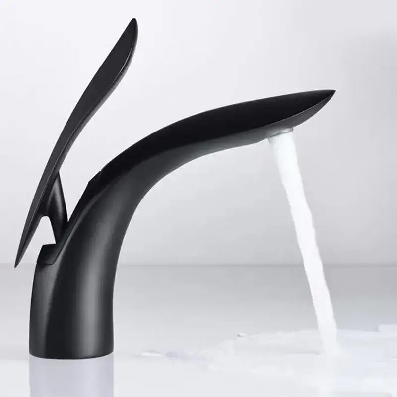 Modern black matte brass basin faucet by decorbites with sleek sculptural design and flowing water stream
