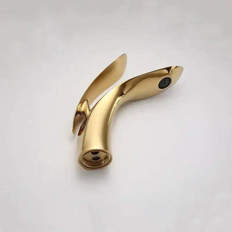 Modern gold brass basin faucet with sleek curved design and polished finish by decorbites for bathroom sink mixer