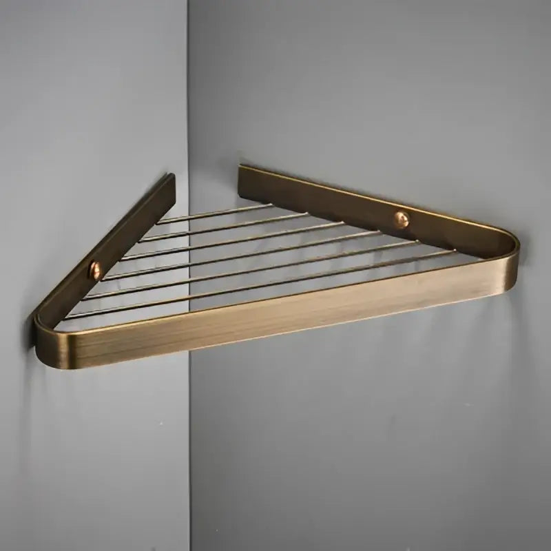 Brass bathroom shower rack with gold triangular corner shelf and wire mesh grid for modern decorbites brass bathroom use