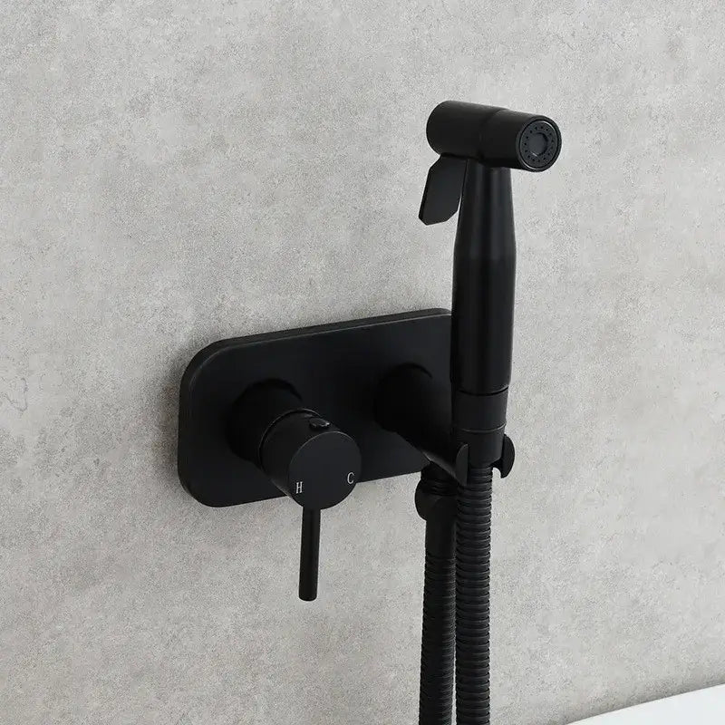 Modern gold brass bidet sprayer set with black matte wall-mounted bidet sprayer and flexible hose for bathroom use