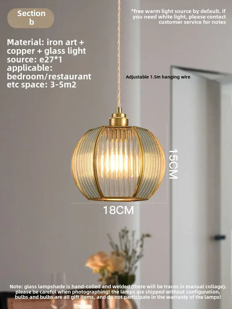 Modern gold brass glass restaurant light with warm-toned spherical ribbed shade and adjustable hanging wire decorbites brass glass