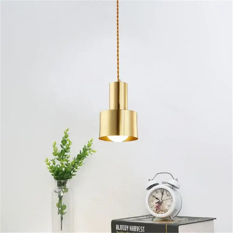 Modern gold brass trumpet pendant light featuring a sleek cylindrical design with twisted cord suspension for decorbites brass trumpet decor