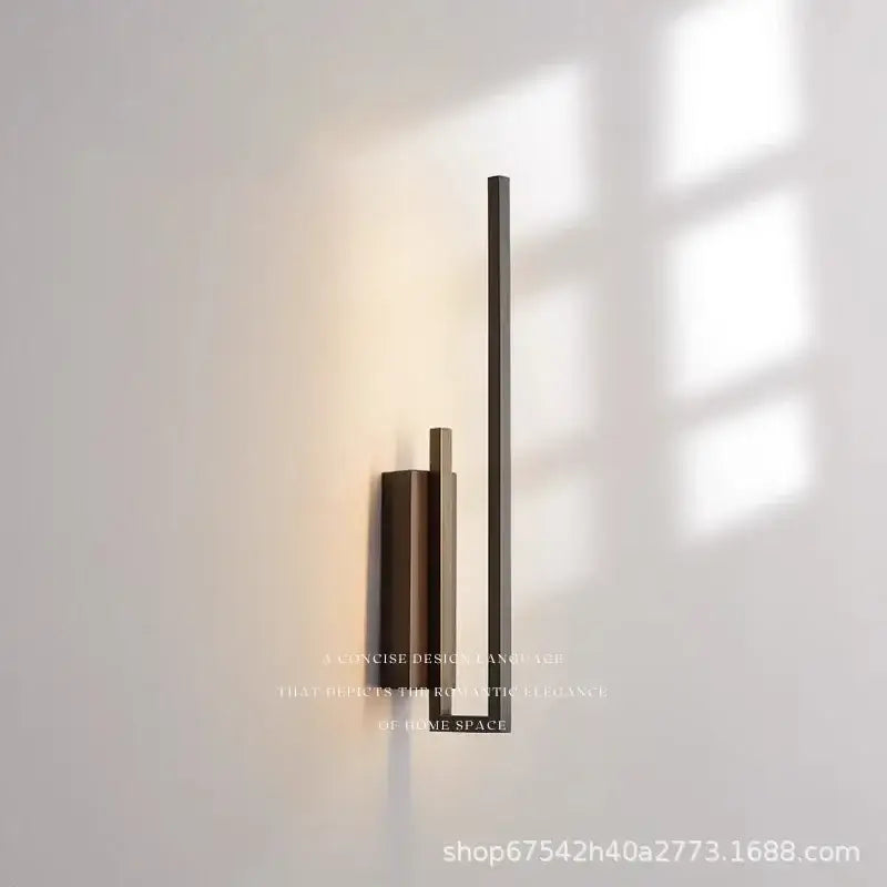 Modern gold brass wall light sconce with three vertical brushed bronze bars and frosted glass emitting warm ambient light