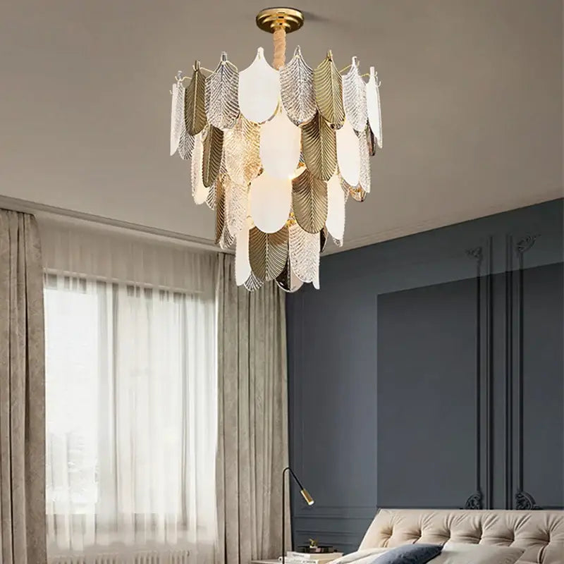 Modern gold and brown elegant glass ceiling chandelier with gold-toned leaf design and layered silver and white glass panels