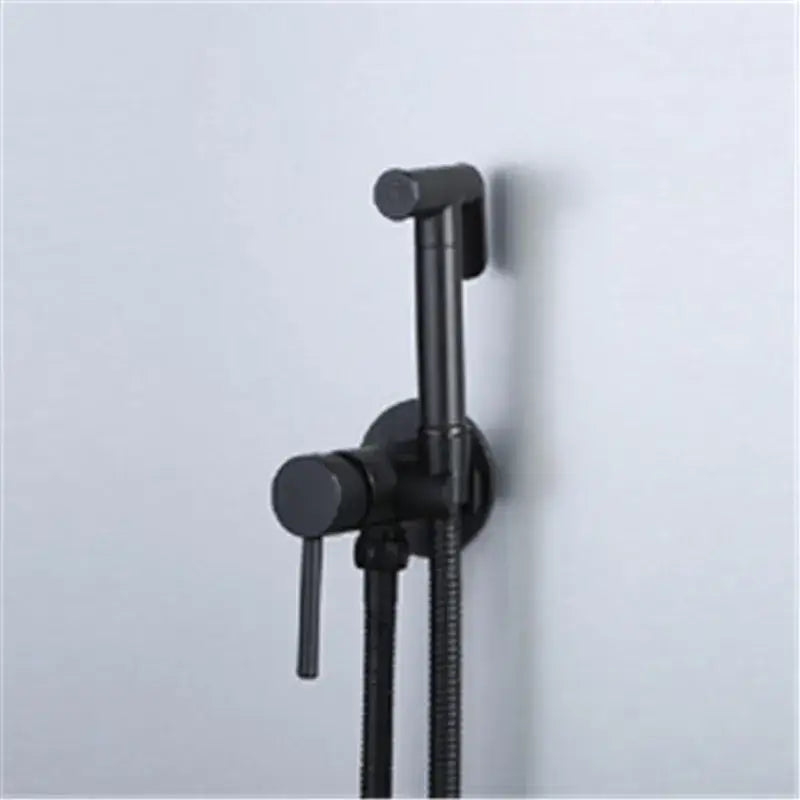 Modern gold brushed brass rose gold and black bidet sprayer set with a sleek black matte wall-mounted sprayer and flexible hose