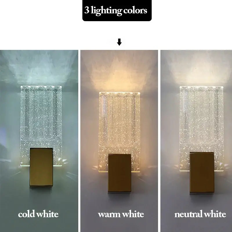 A modern gold led wall sconce with a clear bubble crystal glass panel for living room lighting