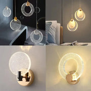 Modern gold bubble crystal pendant lights and wall sconces with sparkling translucent glass and gold-toned metal accents