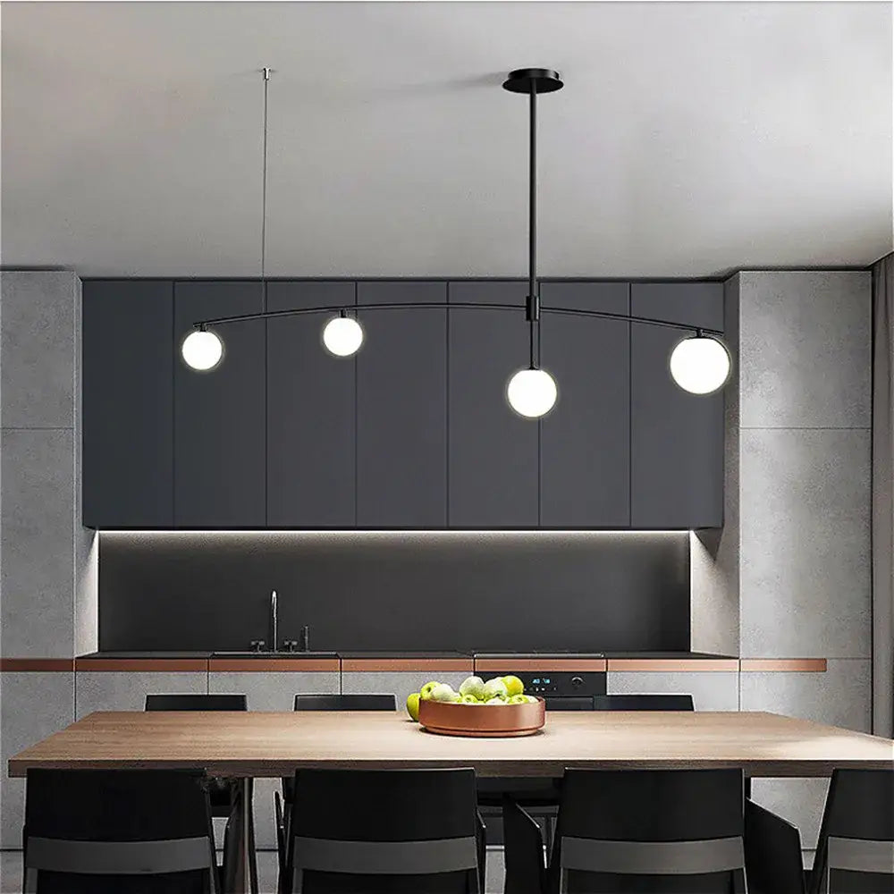 Modern black pendant light with three white spherical bulbs and curved arm from decorbites bubble iron chandelier collection