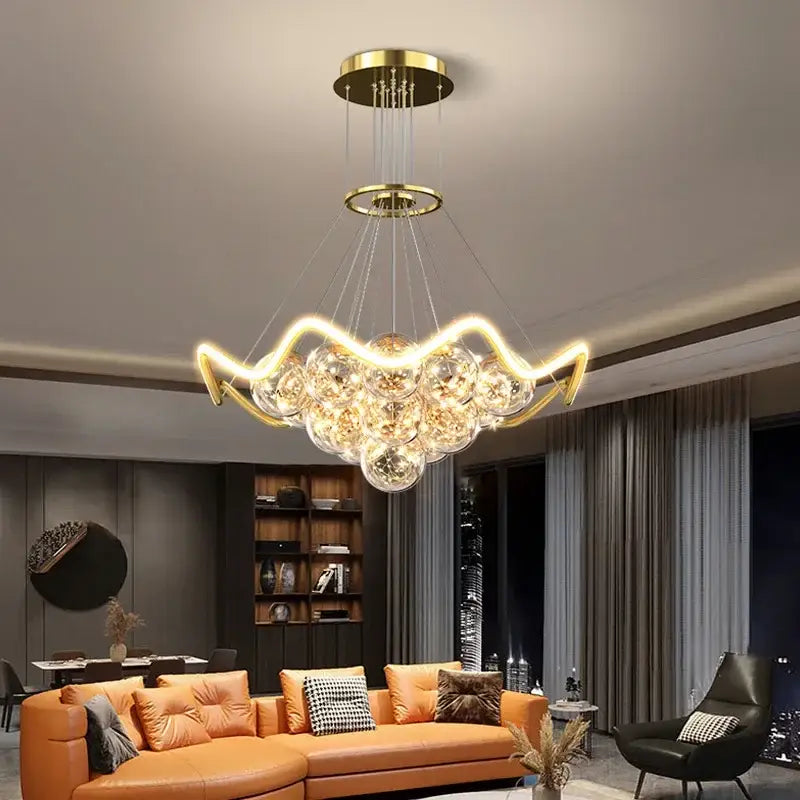 Modern gold bubble pendant chandelier featuring clear glass spheres and curved metallic arms for dining room decorbites bubble pendant