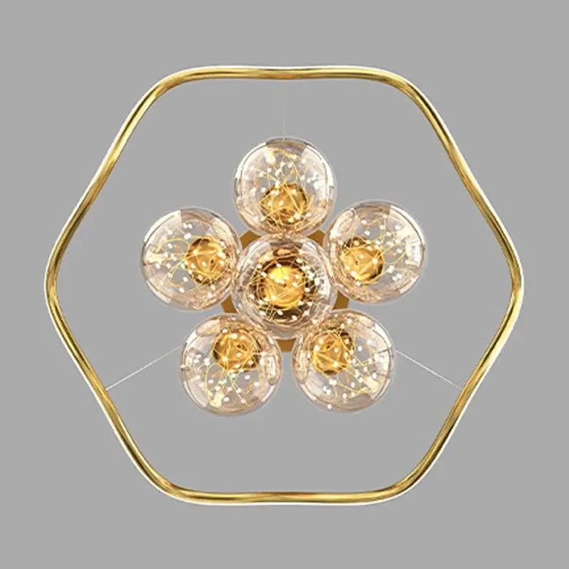 Modern gold bubble pendant chandelier with hexagonal frame and six clear glass globe bulbs for dining room decorbites bubble pendant